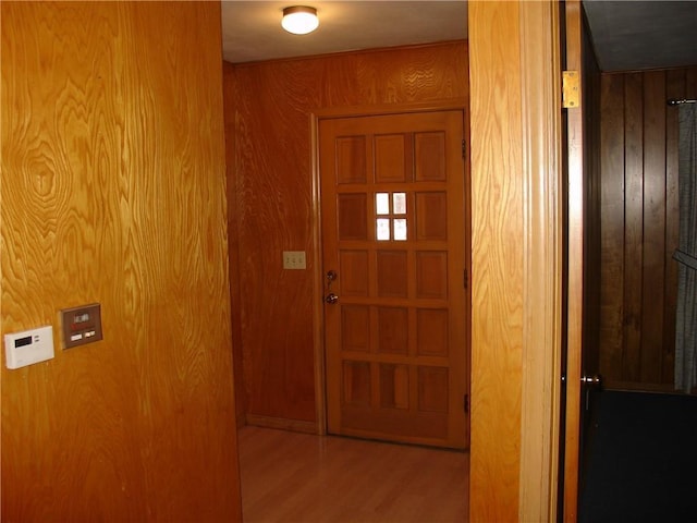 corridor featuring wood walls and wood-type flooring