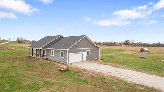 view of home's exterior featuring a yard, a rural view, and a garage