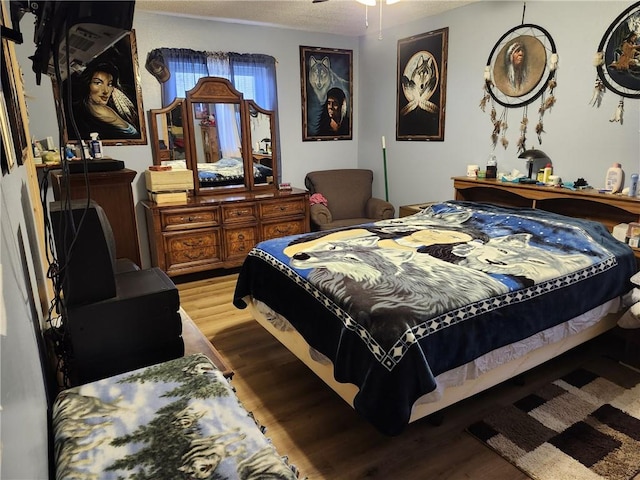 bedroom featuring hardwood / wood-style floors and a textured ceiling