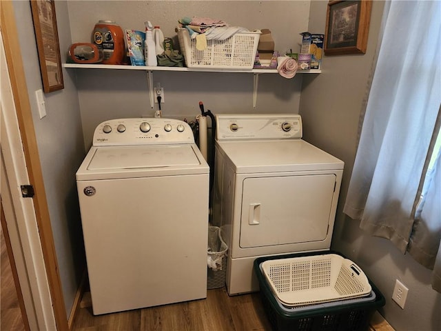 laundry area with separate washer and dryer and dark hardwood / wood-style flooring