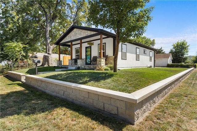 view of front of house with a front yard and covered porch