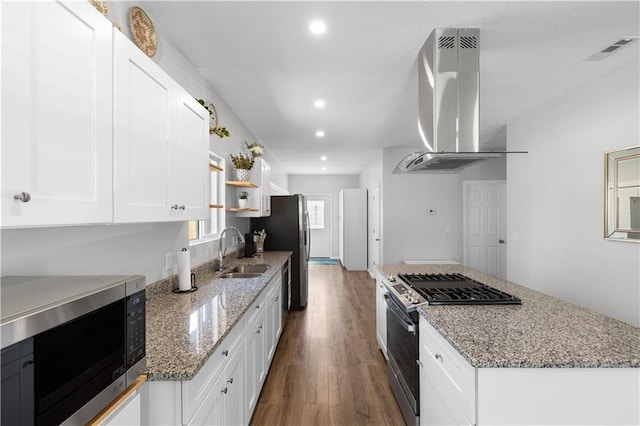 kitchen featuring sink, white cabinetry, stainless steel appliances, light stone countertops, and exhaust hood