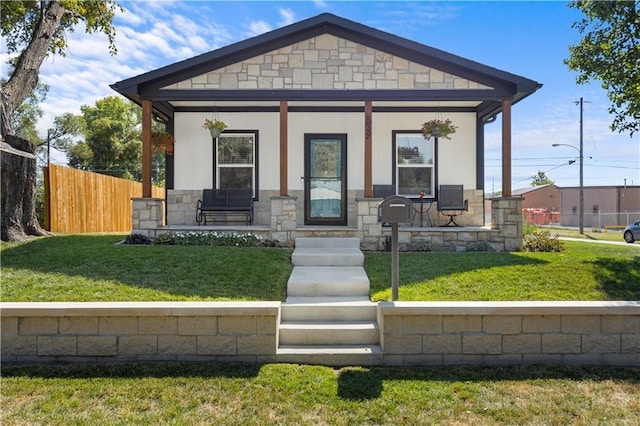 bungalow with a porch and a front yard