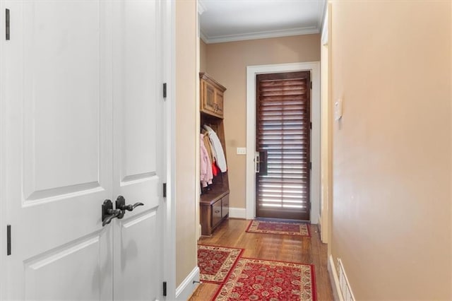 doorway to outside with light wood-type flooring and ornamental molding