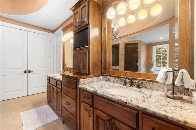 bathroom with tile patterned flooring, vanity, and ornamental molding