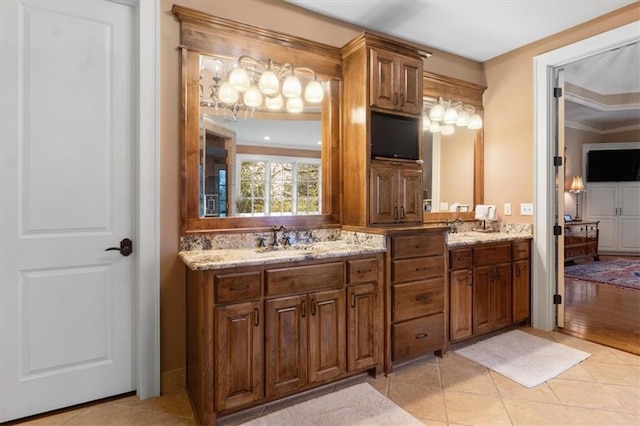 bathroom featuring crown molding, tile patterned flooring, and vanity