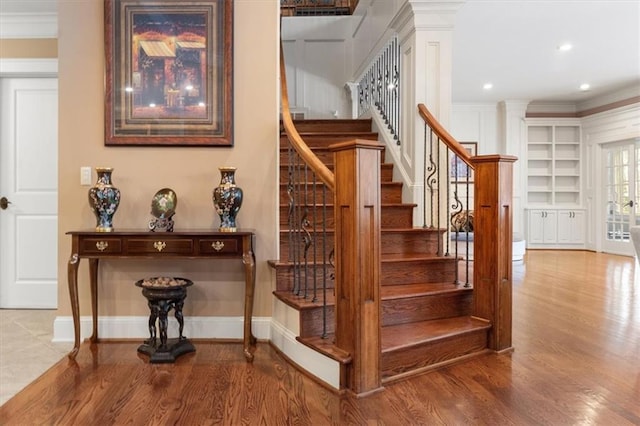 stairway featuring crown molding and hardwood / wood-style floors