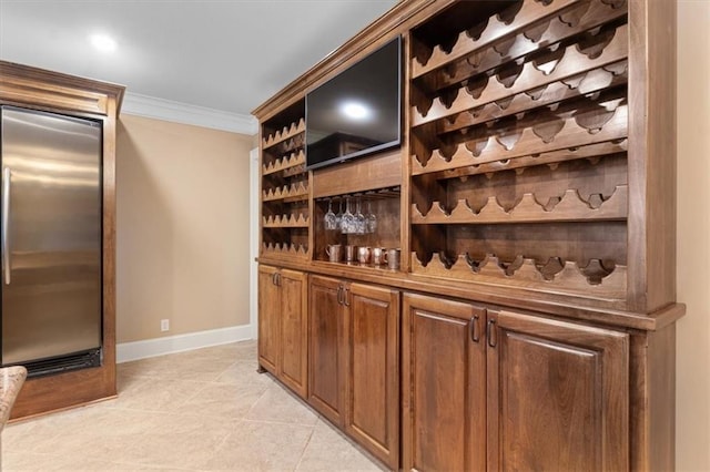 wine room featuring light tile patterned floors and ornamental molding