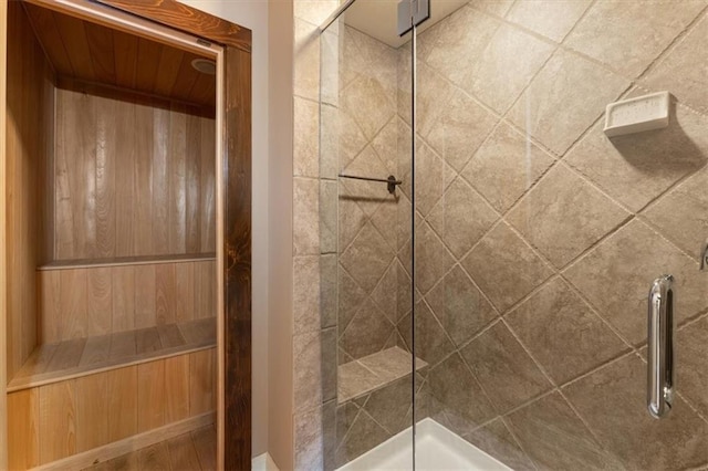 bathroom with a shower with door