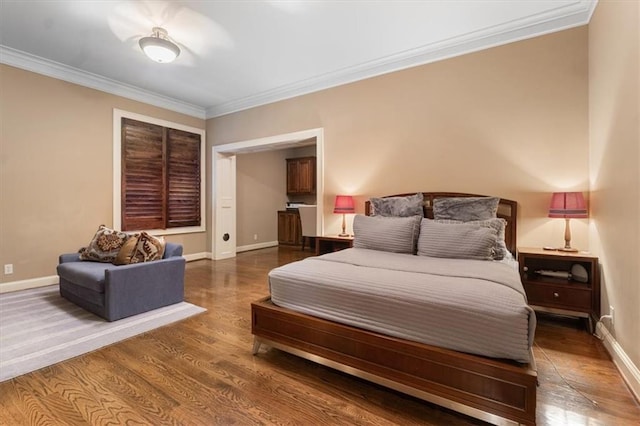 bedroom with dark hardwood / wood-style floors and crown molding