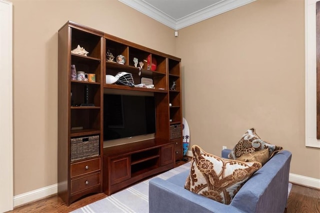 living area featuring wood-type flooring and ornamental molding