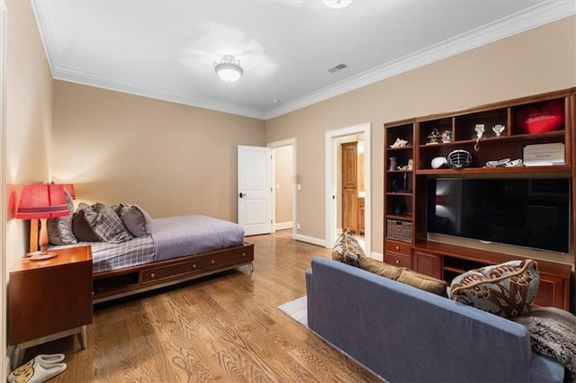 bedroom with hardwood / wood-style flooring and ornamental molding