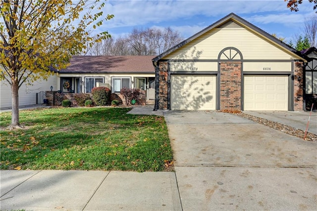 ranch-style house featuring a front yard and a garage