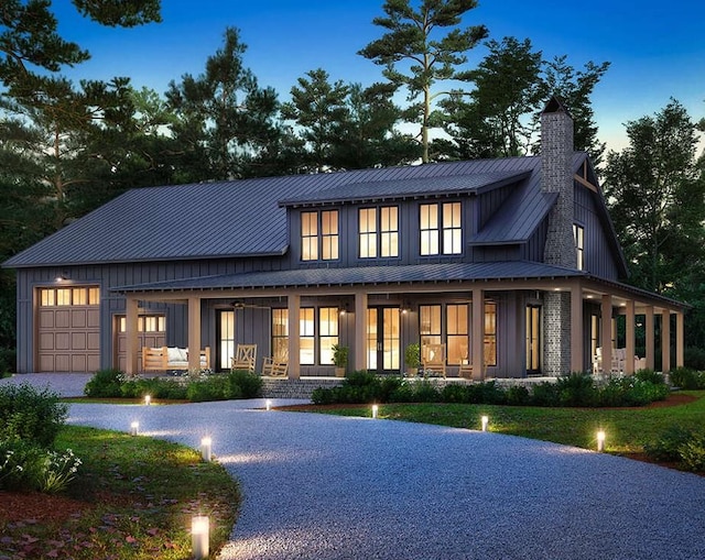 modern inspired farmhouse featuring a porch and a garage