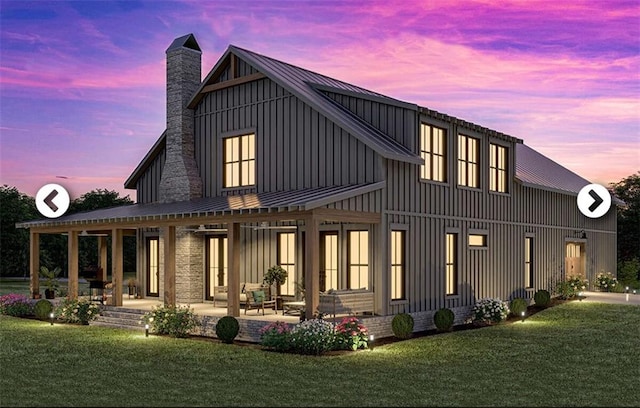 back house at dusk with a yard and a patio