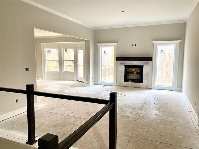 unfurnished living room featuring ornamental molding and a fireplace