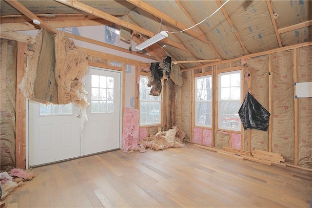 misc room with hardwood / wood-style flooring and lofted ceiling