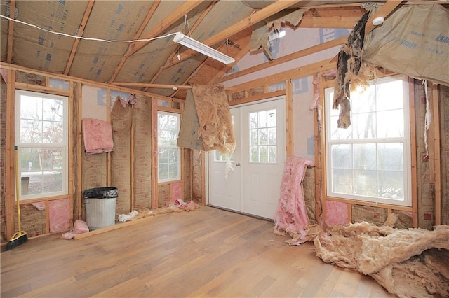 miscellaneous room featuring hardwood / wood-style floors, vaulted ceiling, and plenty of natural light