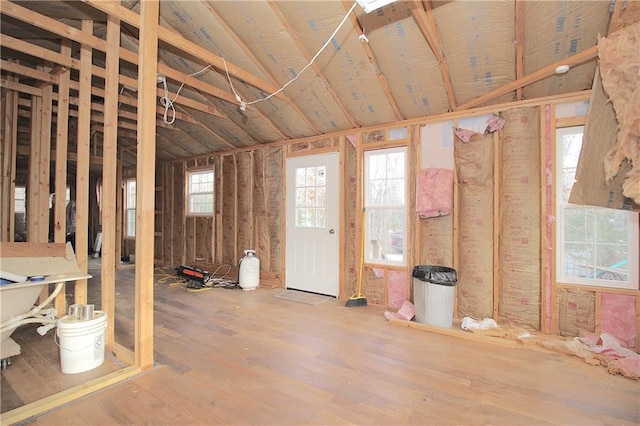 miscellaneous room featuring hardwood / wood-style floors and lofted ceiling