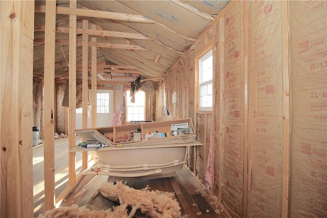 bathroom featuring lofted ceiling