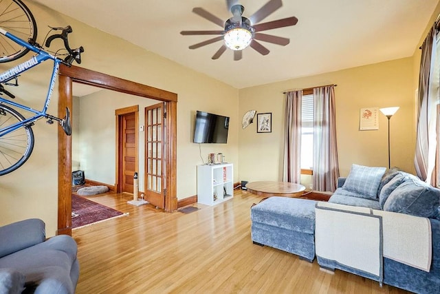 living room with ceiling fan and hardwood / wood-style flooring