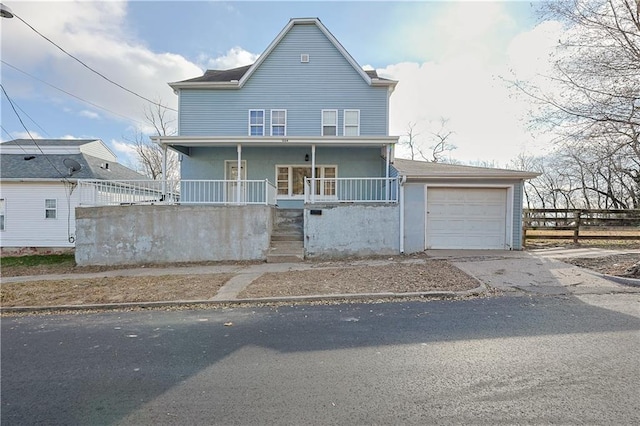 view of front of house featuring a garage and a porch