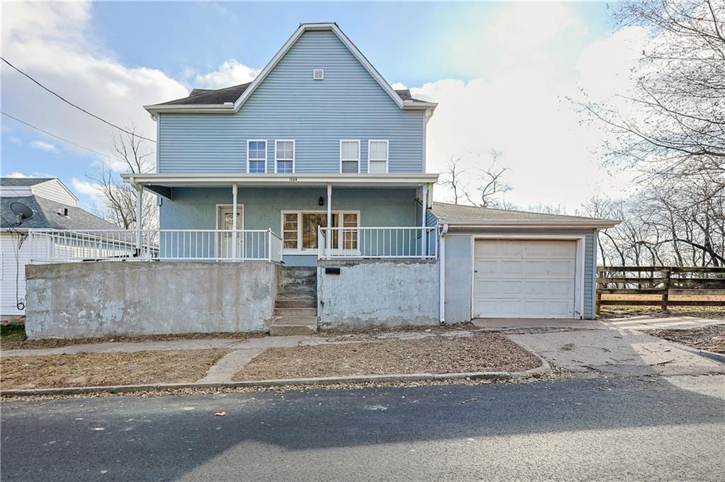 view of front of property featuring a garage and a porch