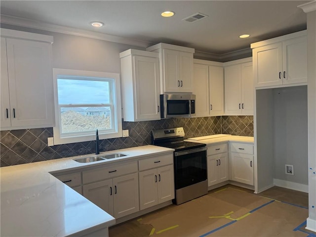 kitchen featuring stainless steel appliances, visible vents, a sink, and white cabinetry