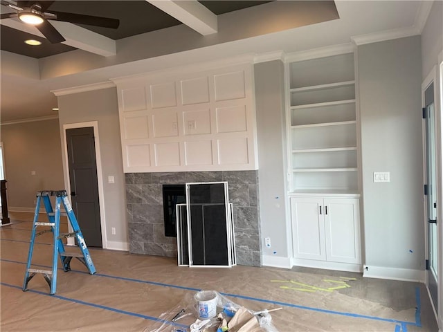 unfurnished living room featuring ornamental molding, built in shelves, a fireplace, and baseboards