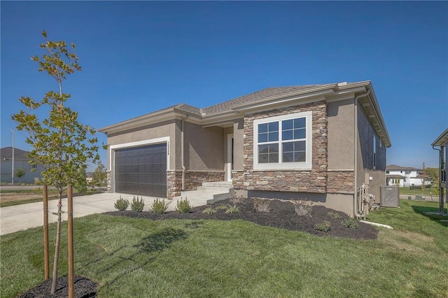 prairie-style house with a garage, stone siding, a front lawn, and driveway