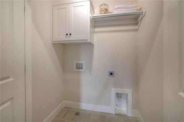 clothes washing area featuring hookup for a washing machine, cabinet space, electric dryer hookup, tile patterned flooring, and baseboards