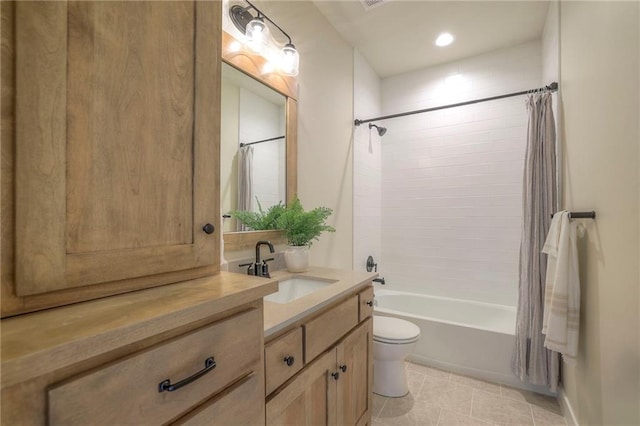 full bath featuring toilet, tile patterned floors, shower / bath combo with shower curtain, and vanity