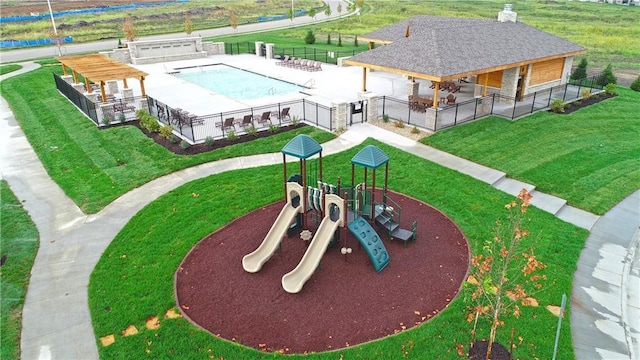 exterior space featuring a yard, playground community, and fence