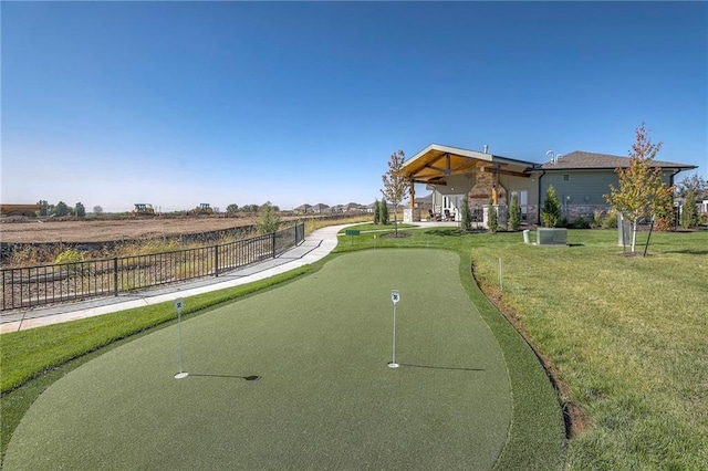 view of property's community with fence and a lawn