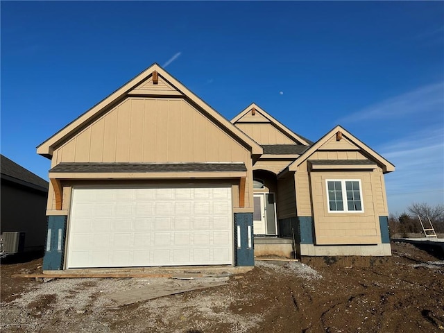 view of front of house featuring a garage and central AC unit