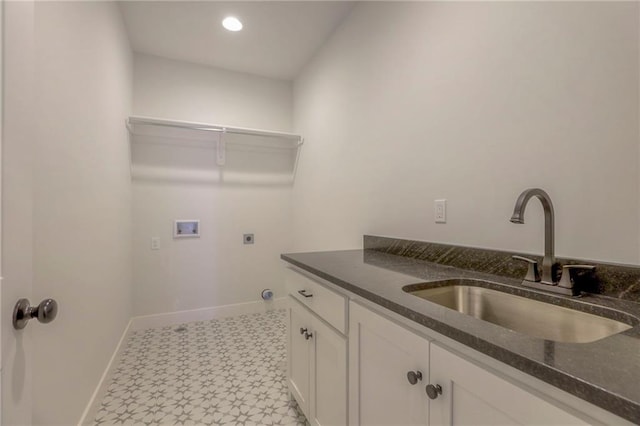 washroom featuring washer hookup, sink, cabinets, and hookup for an electric dryer