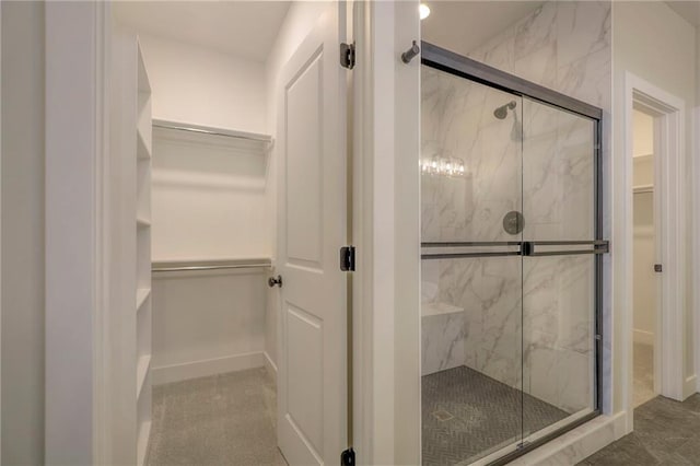 bathroom with a shower with door