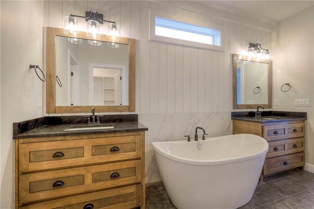 bathroom with vanity and a tub