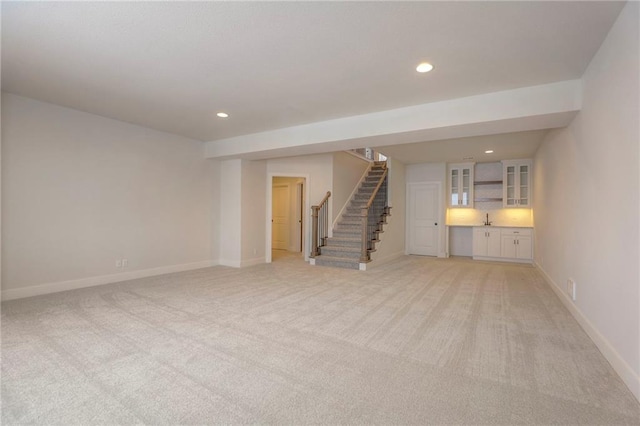 unfurnished living room featuring light colored carpet