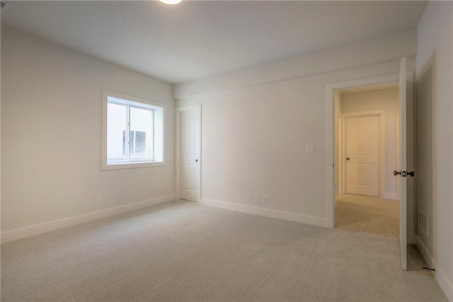 empty room featuring light carpet