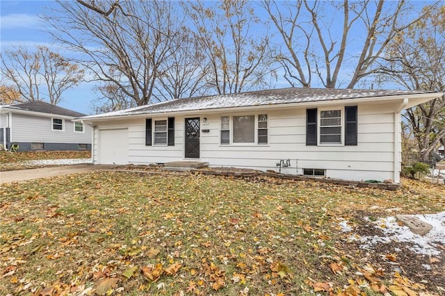 ranch-style home with a garage and a front lawn