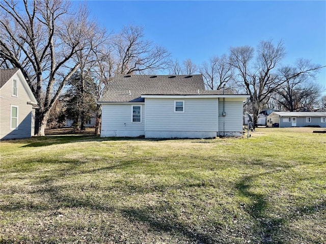 back of property featuring a lawn