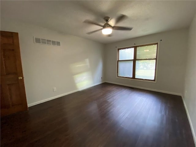 unfurnished room featuring ceiling fan and dark wood-type flooring