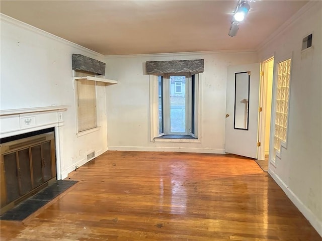 unfurnished living room with hardwood / wood-style flooring and ornamental molding