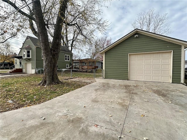 view of side of home with a garage and an outbuilding