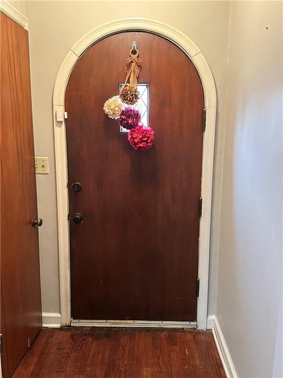 doorway to outside featuring dark wood-type flooring