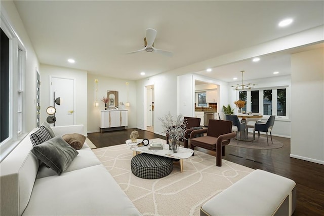 living room with ceiling fan and dark hardwood / wood-style floors