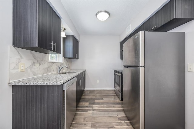 kitchen with backsplash, sink, stainless steel appliances, a textured ceiling, and dark hardwood / wood-style flooring