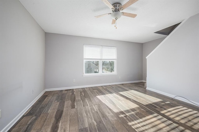 spare room featuring ceiling fan and dark hardwood / wood-style floors