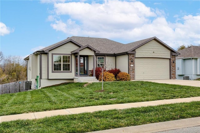 view of front facade with a garage, a front lawn, and cooling unit